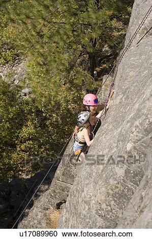 Young woman climbing with daughter (age 7) up granite cliff at Stone Hills near Rexford, Montana, USA View Large Photo Image Stock Image - Young woman climbing with daughter (age 7) up granite cliff at Stone Hills near Rexford, Montana, USA. Fotosearch