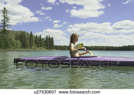Young woman paddling kayak, Lake Katherine, Riding Mountain National Park, Manitoba, Canada View Large Photo Image Stock Photo - Young woman paddling kayak, Lake Katherine, Riding Mountain National Park, Manitoba, Canada. Fotosearch