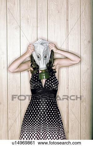 Young woman putting on gas mask View Large Photo Image Stock Image - Young woman putting on gas mask. Fotosearch