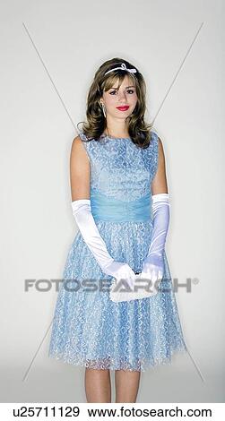 Stock Photo - Young woman wearing 50's style dress and accessories. Fotosearch