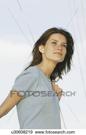 Young woman wearing hemp shirt holds rope on sailboat, Clear Lake, Riding Mountain National Park, Manitoba, Canada View Large Photo Image Stock Photo - Young woman wearing hemp shirt holds rope on sailboat, Clear Lake, Riding Mountain National Park, Manitoba, Canada. Fotosearch
