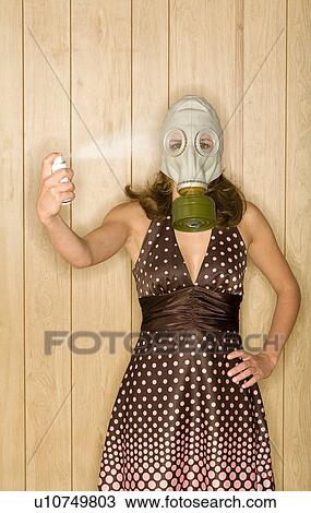 Young woman with gas mask spraying at herself with aerosol can View Large Photo Image Stock Image - Young woman with gas mask spraying at herself with aerosol can. Fotosearch