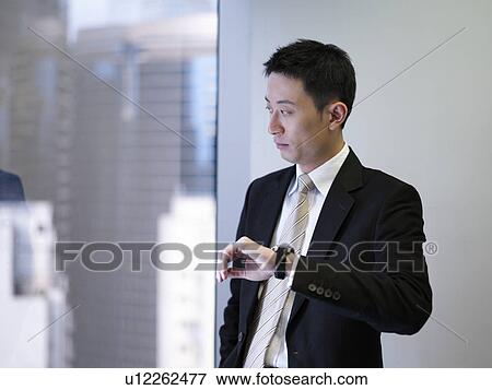 Businessman looking at watch View Large Photo Image Stock Photo - Businessman looking at watch. Fotosearch