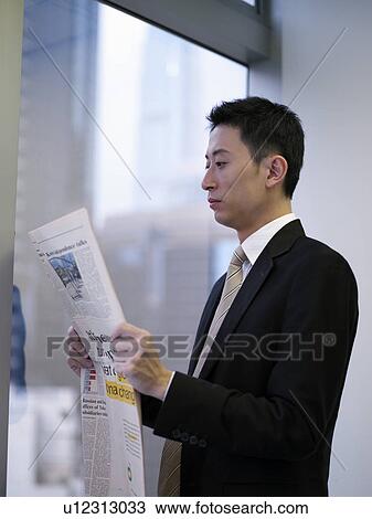 Stock Image - Businessman reading newspaper. Fotosearch