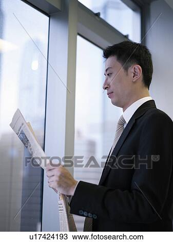 Stock Image - Businessman reading newspaper. Fotosearch