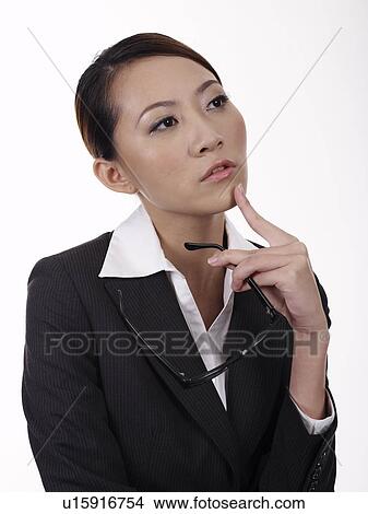 Businesswoman holding spectacles, looking away, close-up View Large Photo Image Picture - Businesswoman holding spectacles, looking away, close-up. Fotosearch