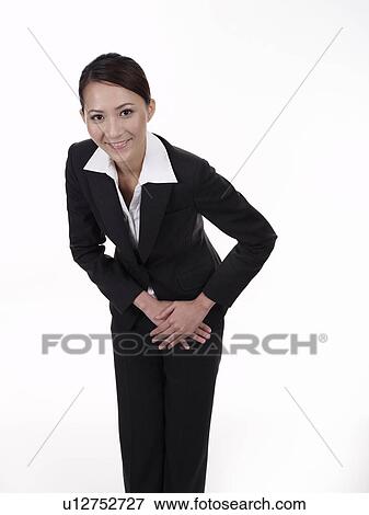 Businesswoman smiling and bowing View Large Photo Image Stock Photo - Businesswoman smiling and bowing. Fotosearch