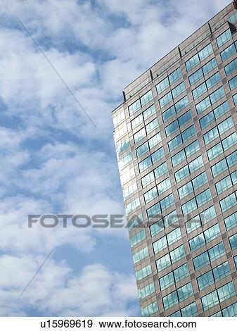 Stock Photo - Clouds reflected on exterior glass panels of building. Fotosearch