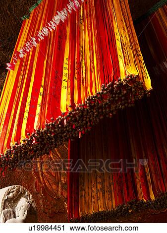 Stock Image - Prayer Strips hanging from Lian Xin Shan. Fotosearch