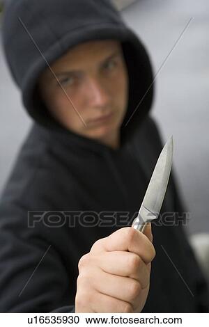 Stock Image - Teenage Boy Branding Knife. Fotosearch