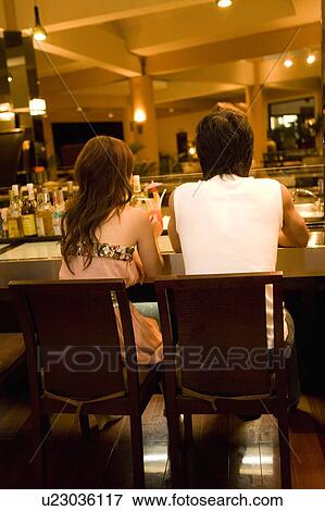Stock Photo - Couple at a bar, Saipan. Fotosearch