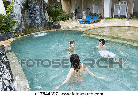 Stock Photo - Friends playing in swimming pool, Saipan. Fotosearch
