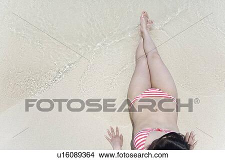 Woman lying on beach, Saipan, USA View Large Photo Image Picture - Woman lying on beach, Saipan, USA . Fotosearch