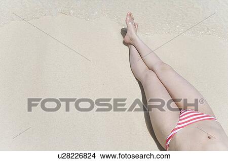 Woman lying on beach, Saipan, USA View Large Photo Image Picture - Woman lying on beach, Saipan, USA . Fotosearch