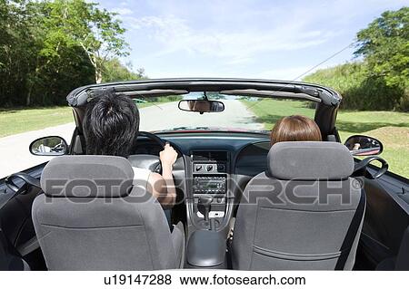 Young couple in the car, man holding steering wheel, Saipan, USA View Large Photo Image Stock Photo - Young couple in the car, man holding steering wheel, Saipan, USA. Fotosearch