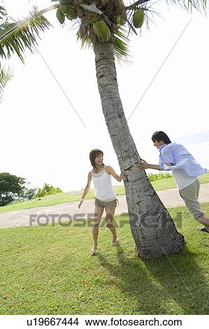 Young man chasing Young woman, Saipan View Large Photo Image Picture - Young man chasing Young woman, Saipan. Fotosearch