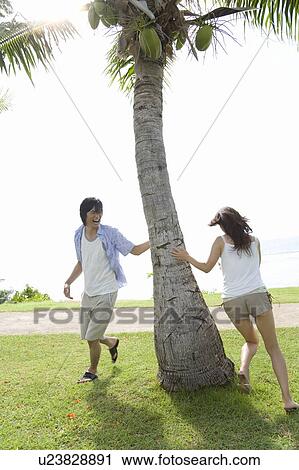 Young man chasing Young woman, Saipan View Large Photo Image Stock Image - Young man chasing Young woman, Saipan. Fotosearch