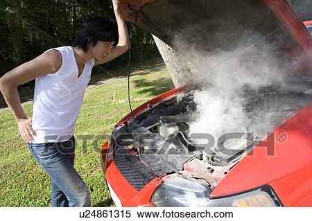 Young man looking at car engine, Saipan, USA View Large Photo Image Stock Photography - Young man looking at car engine, Saipan, USA . Fotosearch