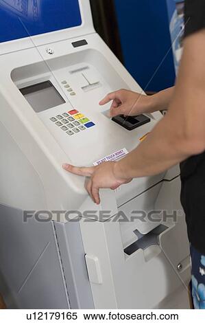 Young Man using ATM machine, Saipan View Large Photo Image Stock Photography - Young Man using ATM machine, Saipan. Fotosearch