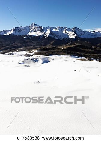 Stock Photo - Aerial landscape of Colorado Rockies with snow covered valley. Fotosearch