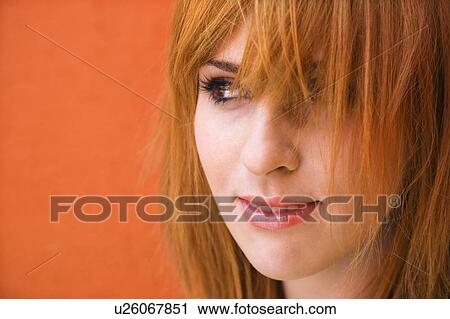 Close-up portrait of smiling young redheaded female looking mischievious. View Large Photo Image Stock Image - Close-up portrait of smiling young redheaded female looking mischievious.. Fotosearch