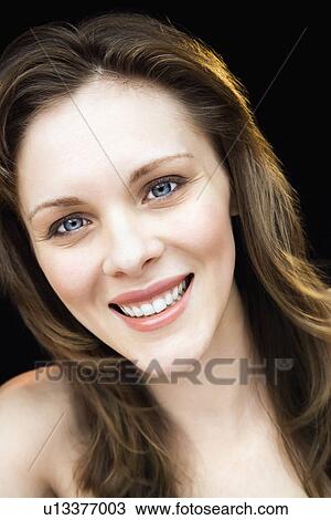 Stock Image - Close up portrait of young adult female smiling. Fotosearch
