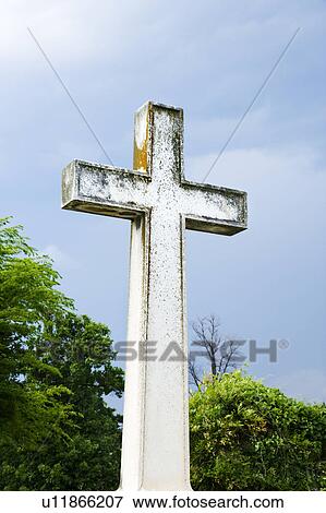 Cross in graveyard against blue sky and clouds View Large Photo Image Stock Photo - Cross in graveyard against blue sky and clouds. Fotosearch
