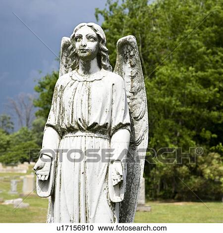 Stock Image - Guardian Angel statue in graveyard. Fotosearch