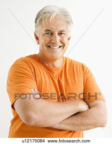Picture - Portrait of smiling adult man standing looking at viewer with arms crossed.. Fotosearch