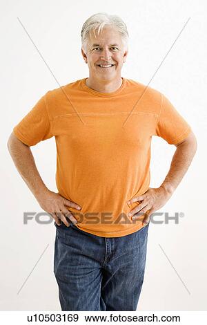 Stock Photo - Portrait of smiling adult man standing looking at viewer.. Fotosearch