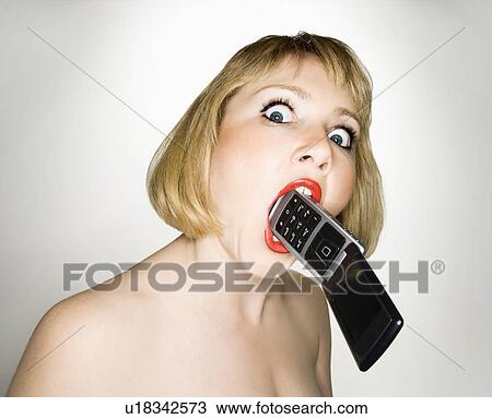 Portrait of young blonde caucasian woman who has a cellphone in her mouth. View Large Photo Image Stock Image - Portrait of young blonde caucasian woman who has a cellphone in her mouth.. Fotosearch