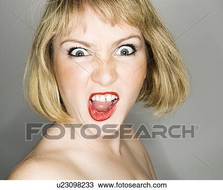 Portrait of young blonde caucasian woman who is looking at the viewer with angry expression. View Large Photo Image Stock Image - Portrait of young blonde caucasian woman who is looking at the viewer with angry expression.. Fotosearch
