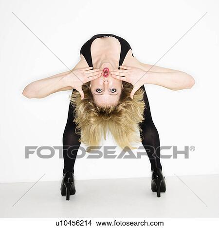 Picture - Portrait of young caucasian woman bending over backwards.. Fotosearch