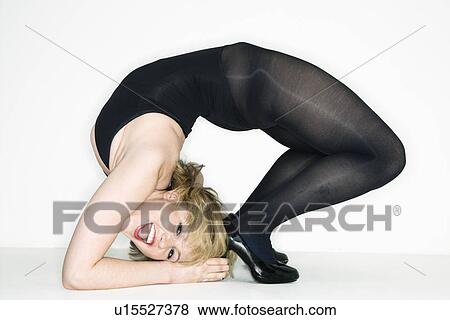 Stock Photo - Portrait of young caucasian woman bending over backwards.. Fotosearch