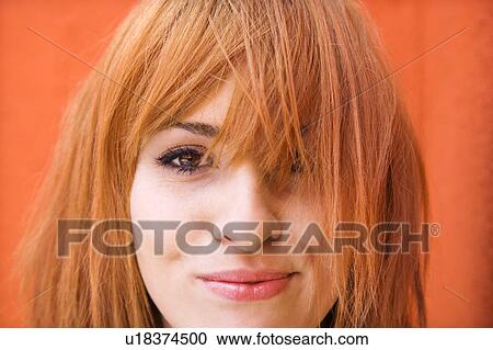 Stock Image - Redheaded woman with funny expression. Fotosearch