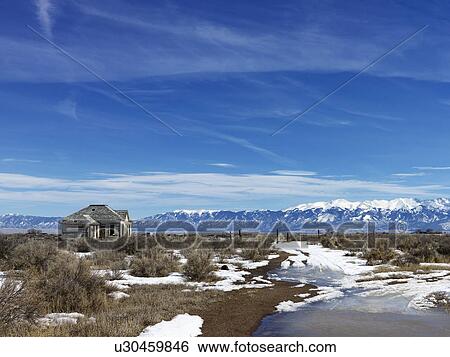 Stock Photograph - Scenic landscape in rural snowy Colorado of abandoned house.. Fotosearch