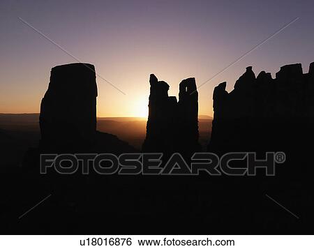 Scenic sunset landscape of mesas in Monument Valley near the border of Arizona and Utah, United States View Large Photo Image Stock Photograph - Scenic sunset landscape of mesas in Monument Valley near the border of Arizona and Utah, United States. Fotosearch
