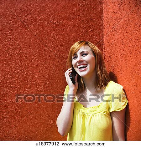 Stock Image - Smiling female talking on cellphone. Fotosearch