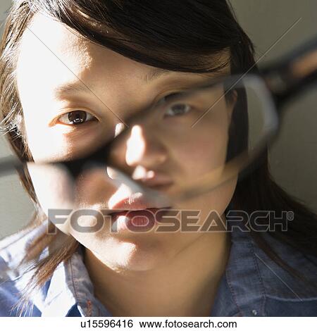 Woman holding eyeglasses View Large Photo Image Stock Photograph - Woman holding eyeglasses. Fotosearch