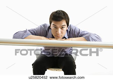 Young Asian business man with head on desk looking at viewer. View Large Photo Image Stock Image - Young Asian business man with head on desk looking at viewer.. Fotosearch