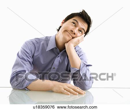 Young business man sitting and daydreaming. View Large Photo Image Stock Photograph - Young business man sitting and daydreaming.. Fotosearch