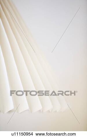 Accordion lampshade against white wall View Large Photo Image Picture - Accordion lampshade against white wall. Fotosearch