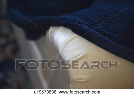 Arm of sofa with blue throw blanket View Large Photo Image Stock Photograph - Arm of sofa with blue throw blanket. Fotosearch