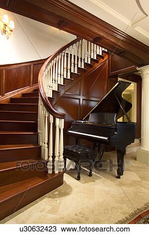 Baby grand piano at foot of large winding staircase View Large Photo Image Stock Image - Baby grand piano at foot of large winding staircase. Fotosearch