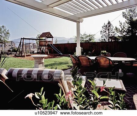 Backyard patio and playground in yard View Large Photo Image Stock Photo - Backyard patio and playground in yard. Fotosearch