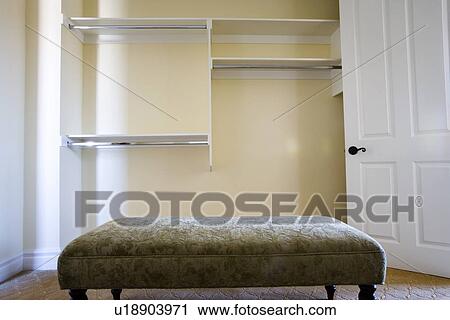 Bench inside empty walk in closet View Large Photo Image Stock Image - Bench inside empty walk in closet. Fotosearch