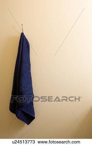 Blue bath towel hanging on wall View Large Photo Image Stock Image - Blue bath towel hanging on wall. Fotosearch