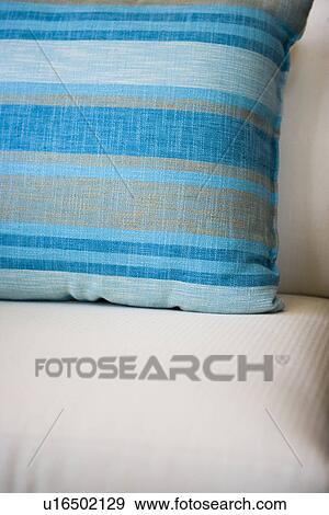 Blue striped throw pillow on white cushion chair View Large Photo Image Stock Photo - Blue striped throw pillow on white cushion chair. Fotosearch