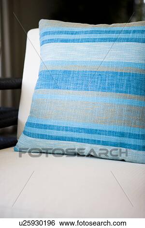 Blue striped throw pillow on white cushion chair View Large Photo Image Stock Photograph - Blue striped throw pillow on white cushion chair. Fotosearch