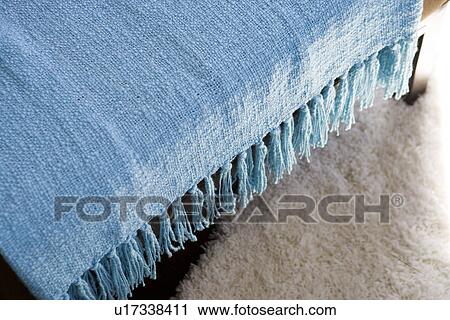 Blue throw blanket with tassels hanging over chair View Large Photo Image Stock Image - Blue throw blanket with tassels hanging over chair. Fotosearch